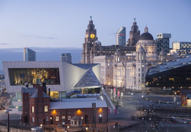 Liverpool, UK - February 3, 2015: Liverpool Pier Head at dusk. Significant buildings from left to right include the Museum of Liverpool, the Royal Liver Building, the Cunard Building, the Port of Liverpool Building and the Mann Island Development.